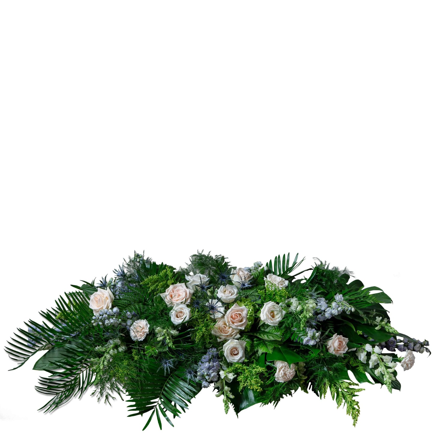 Elegant casket spray with soft pink roses, lush greenery, and delicate blue flowers for heartfelt remembrance