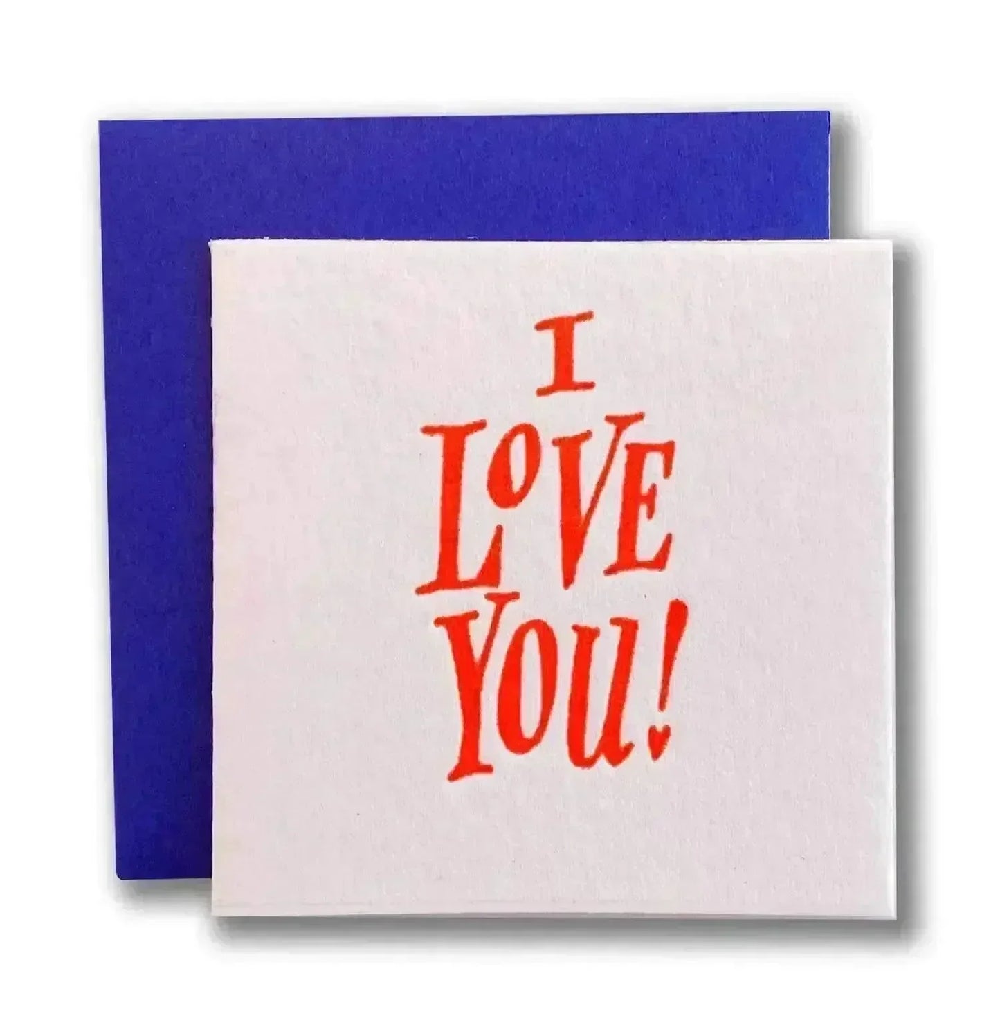White greeting card with bold red text saying 'I LOVE YOU!' and a blue envelope behind it