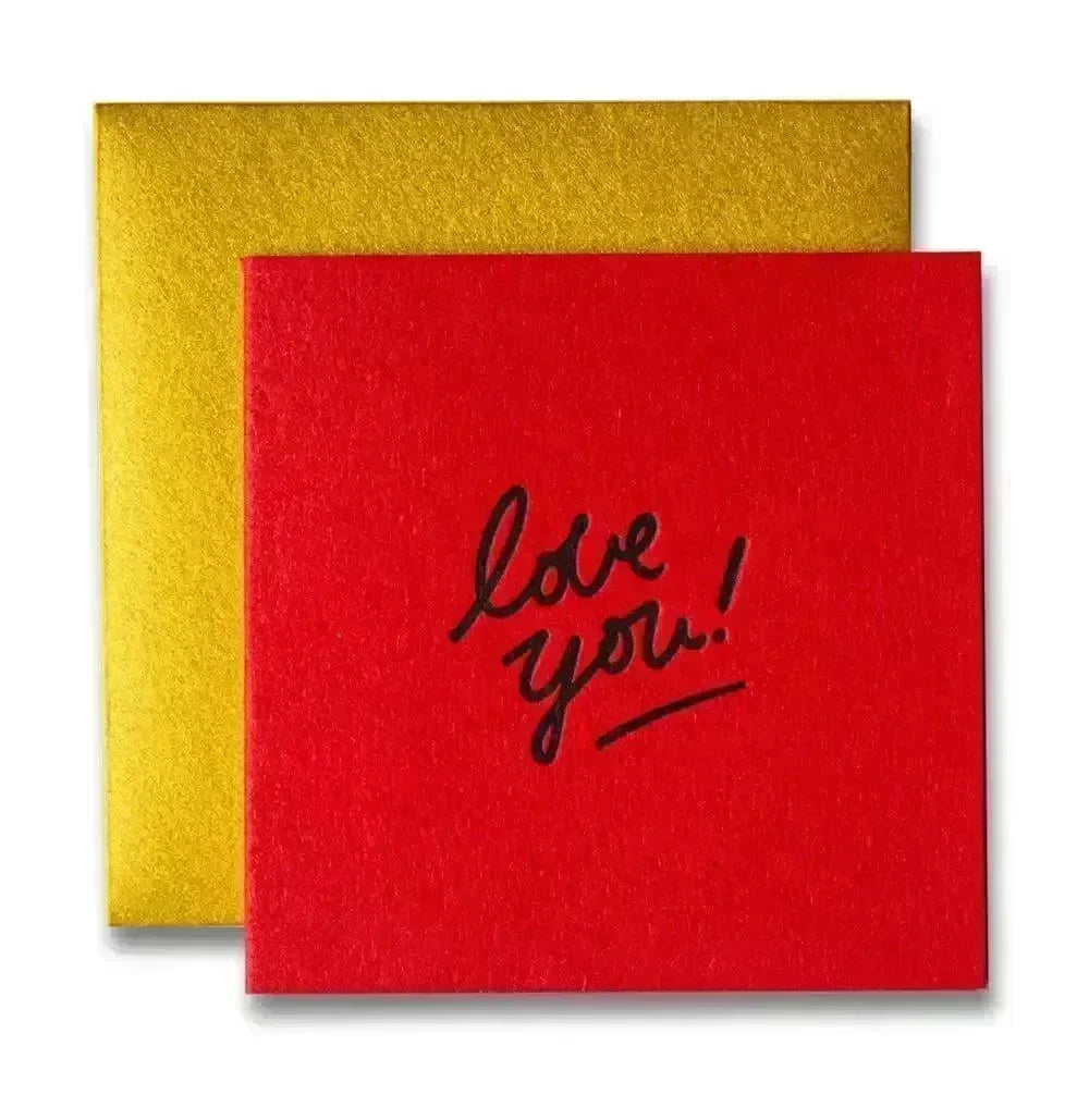 Red card with handwritten 'love you!' message and a golden envelope, bright heartfelt greeting