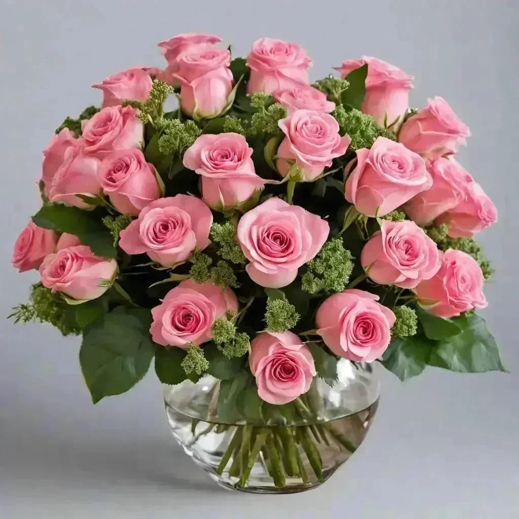 Elegant bouquet of a dozen pink roses with green foliage in a clear glass vase, bright and uplifting