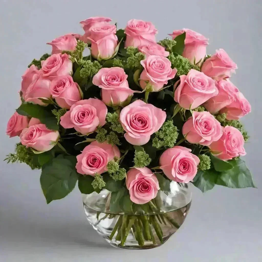 Elegant bouquet of a dozen pink roses with green foliage in a clear glass vase, bright and uplifting