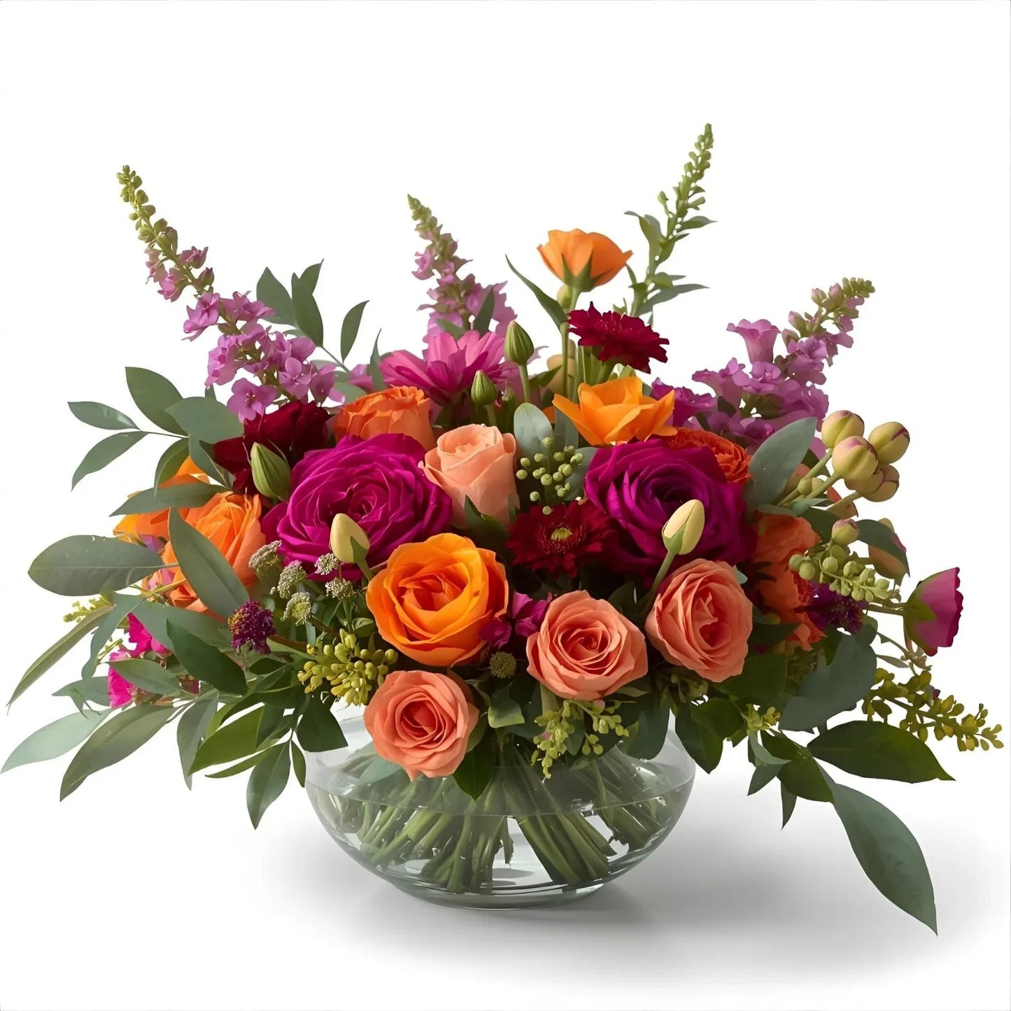 Bouquet of colorful flowers in a clear vase on a white background
