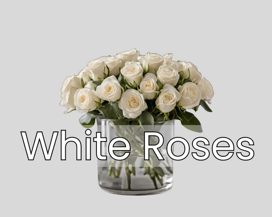 A bouquet of fresh white roses in a clear glass vase for delivery in the Las Vegas area.