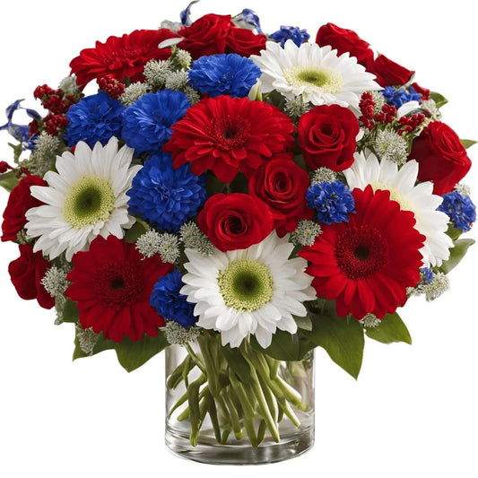 Uplifting patriotic bouquet of red roses, white daisies, and blue flowers in a clear vase
