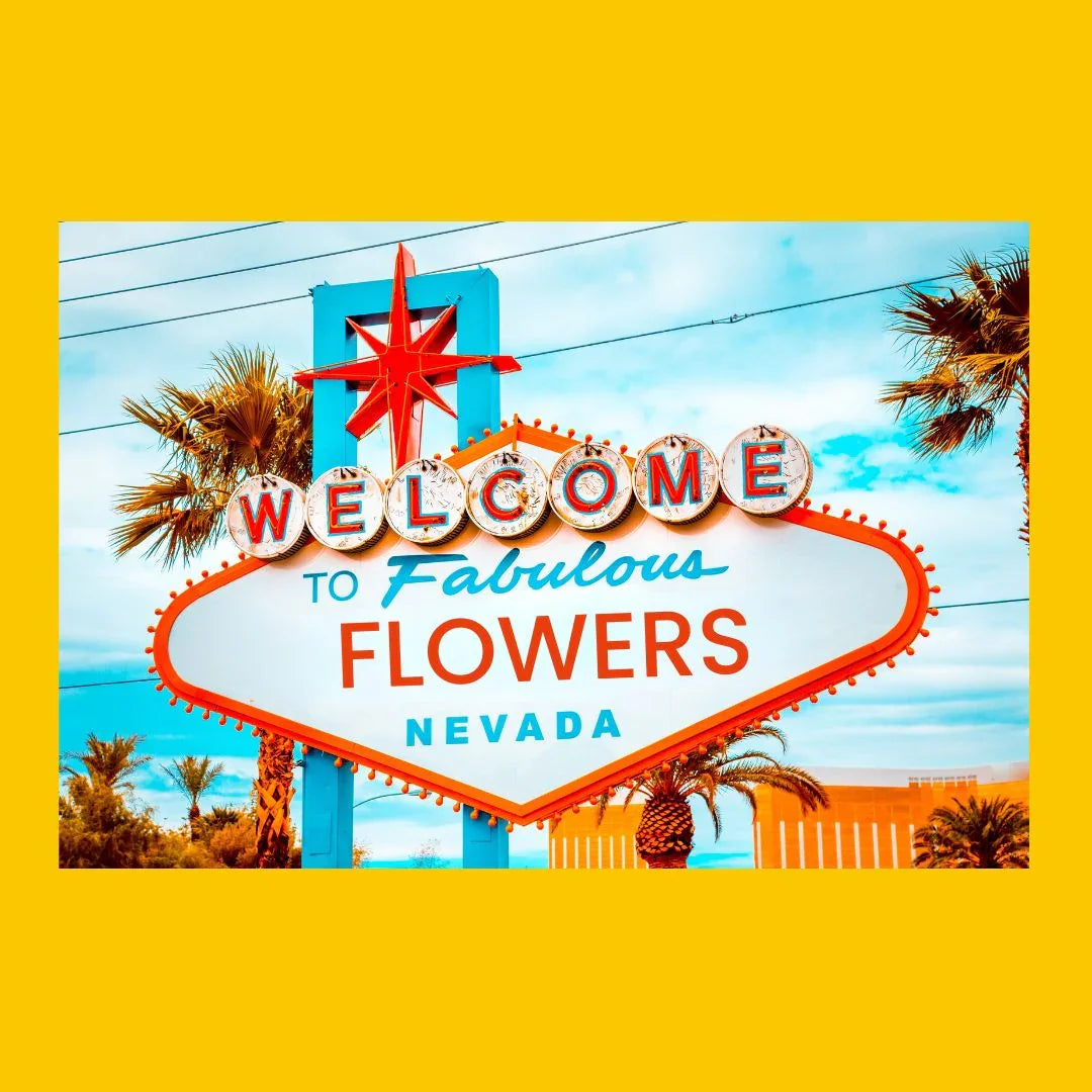 Bright vintage-style sign saying Welcome to Fabulous Flowers Nevada with palm trees and blue sky