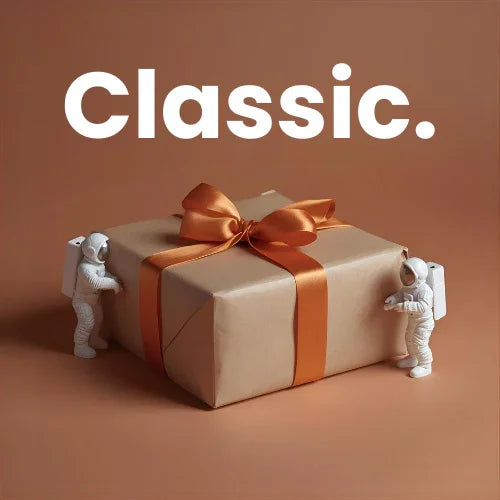 Gift box with orange ribbon and two small astronaut figures on a brown background with 'Classic.' text.