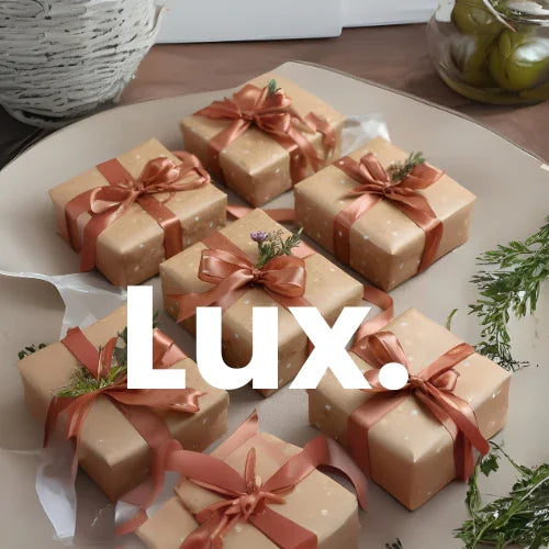 Gift boxes wrapped in brown paper with pink ribbons on a white surface, featuring the brand 'Lux'.