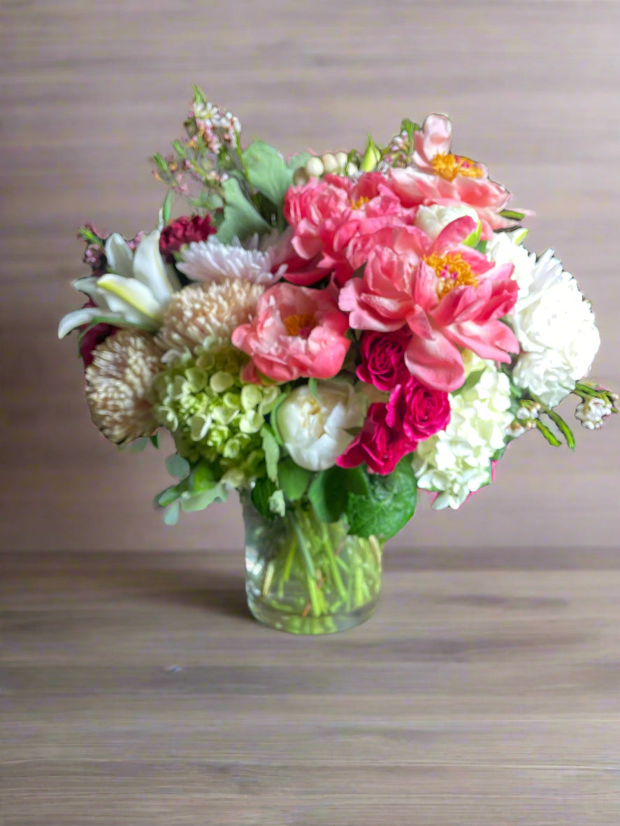A vibrant mix of peonies, spray roses, lilies, chrysanthemum, and hydrangea.