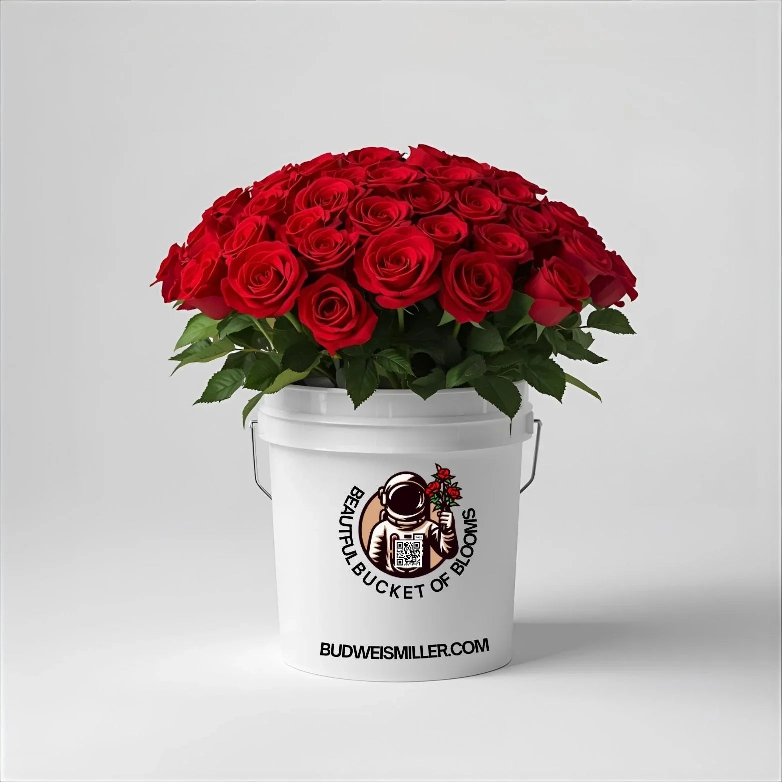 Bright red roses in a white bucket with 'Beautiful Bucket of Blooms' logo, uplifting floral gift