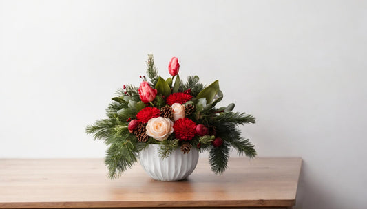 Bud Weismiller's Perfect Christmas Centerpiece which includes cream roses, red pon poms, red tulips, pine cones, and lush seasonal greenery in an up-cycled vase.