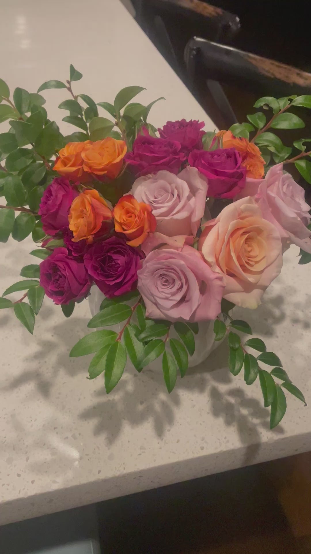 A video of Bud Weismiller's Pumpkin Spice and Everything Nice Bouquet featuring pink and peach roses, burnt orange and fuchsia spray roses, and seasonal greenery all artfully arranged in a pumpkin vase.